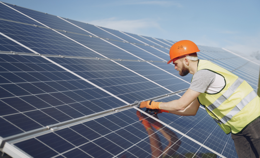 Solar technician installs panels on a roof