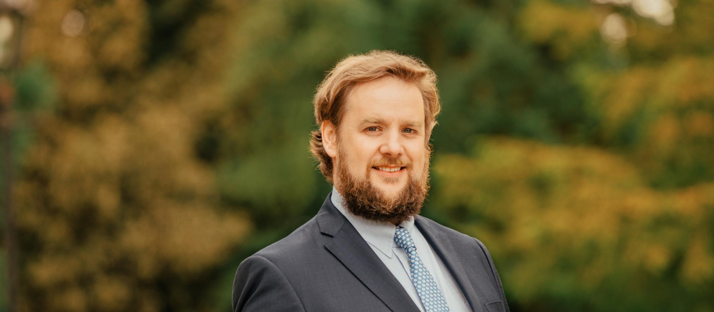 Profile photo of Patrick Costello TD with trees in background