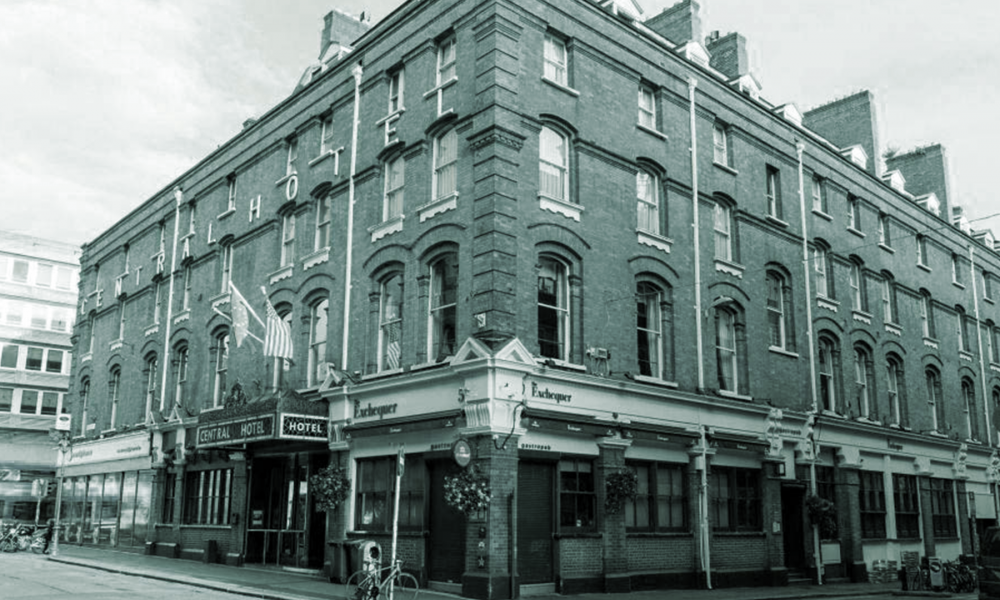 A black and white photo of a building, the Central Hotel on Exchequer St. in Dublin.