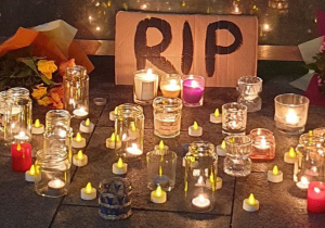 Candles, flowers and signs left at a vigil for Ashling Murphy in January 2022