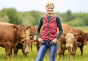Pippa Hackett on a farm with cows in the background