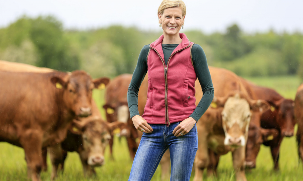 Pippa Hackett on a farm with cows in the background