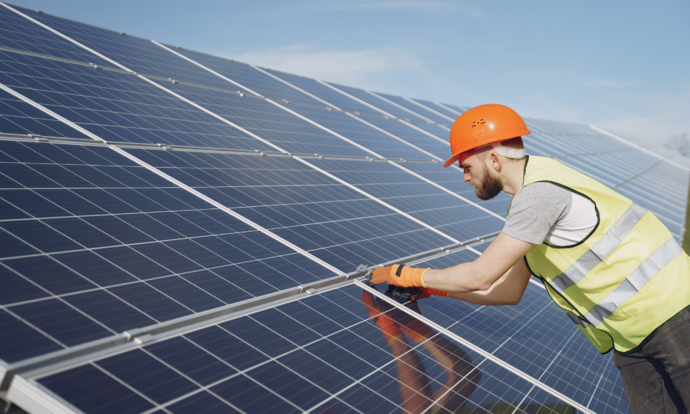 Solar technician installs panels on a roof