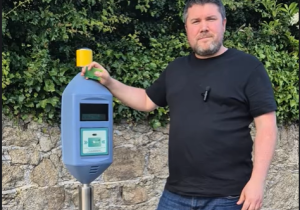 Cllr. Oisín O'Connor at a LUAS stop